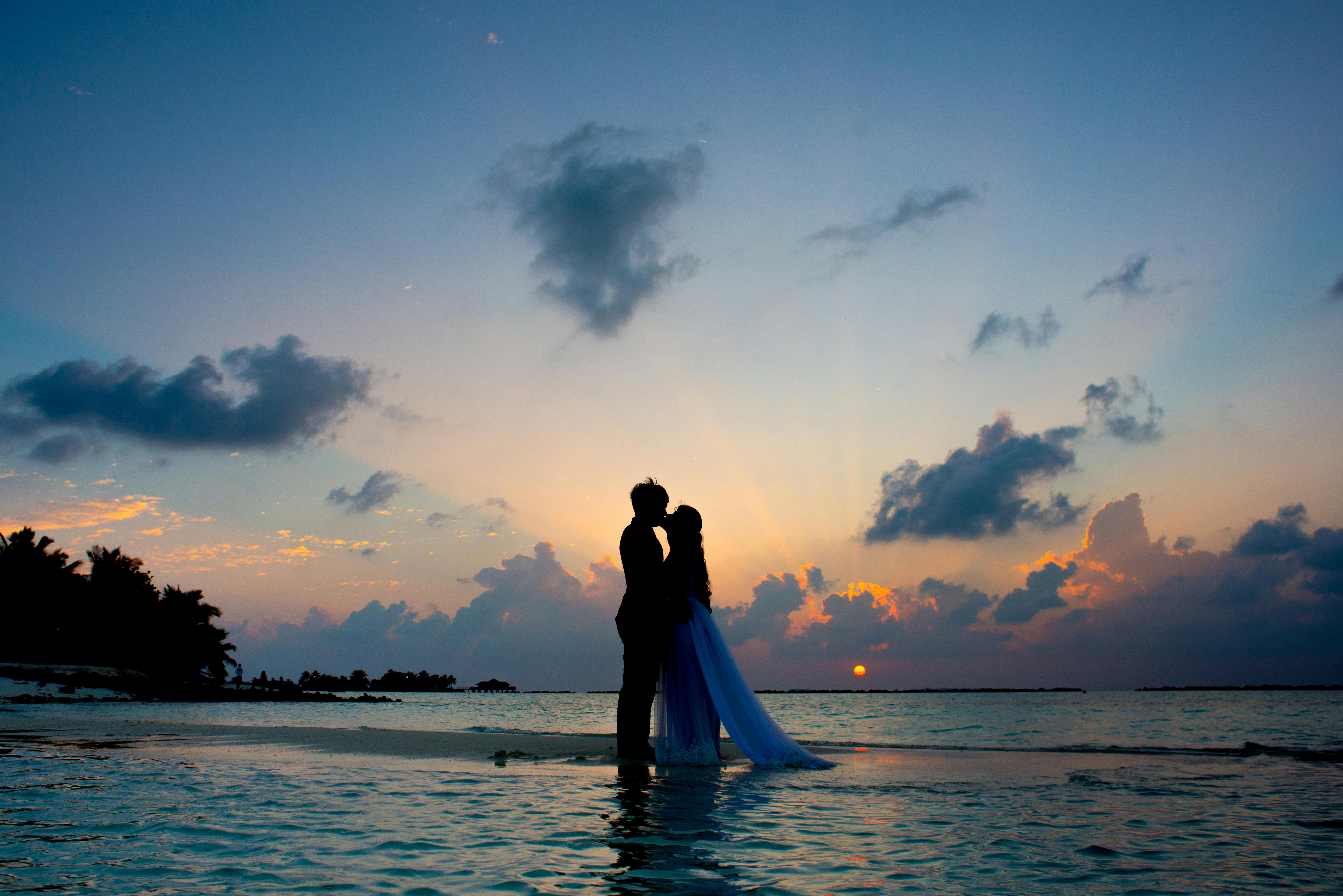 Bride and Groom embracing during sunset